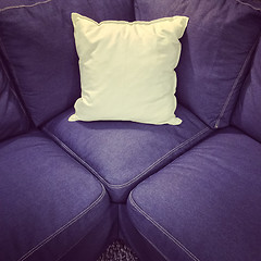 Image showing Blue textile sofa with white cushion