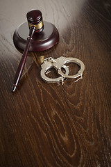 Image showing Gavel and Pair of Handcuffs on Table