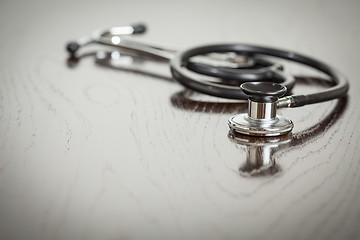 Image showing Doctor Stethoscope Laying on a Reflective Table