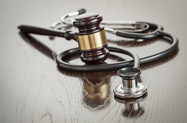 Image showing Gavel and Stethoscope on Reflective Table