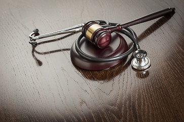 Image showing Gavel and Stethoscope on Reflective Table