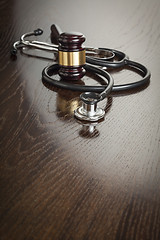 Image showing Gavel and Stethoscope on Reflective Table