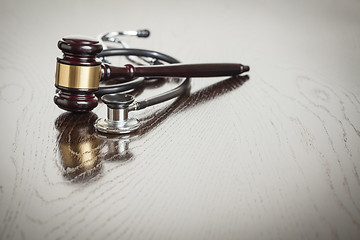 Image showing Gavel and Stethoscope on Reflective Table