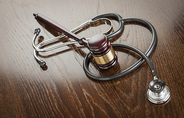 Image showing Gavel and Stethoscope on Reflective Table