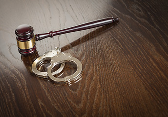 Image showing Gavel and Pair of Handcuffs on Table