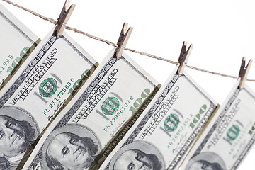 Image showing Hundred Dollar Bills Hanging From Clothesline on White