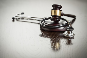 Image showing Gavel and Stethoscope on Reflective Table