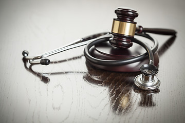 Image showing Gavel and Stethoscope on Reflective Table