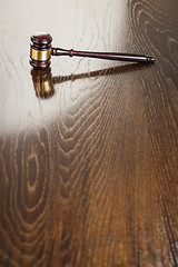 Image showing Wooden Gavel Abstract on Reflective Table