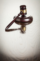 Image showing Wooden Gavel Abstract on Reflective Table