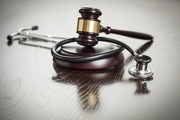 Image showing Gavel and Stethoscope on Reflective Table