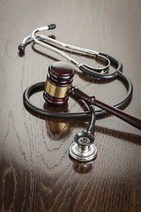 Image showing Gavel and Stethoscope on Reflective Table