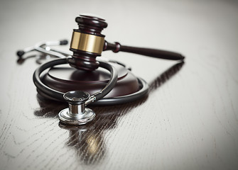 Image showing Gavel and Stethoscope on Reflective Table