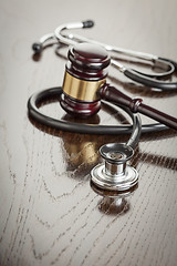 Image showing Gavel and Stethoscope on Reflective Table