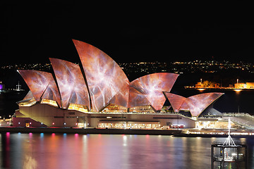 Image showing Sydney Opera House lit with vibrant colours and patterns during 