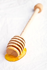 Image showing honey on wooden honey dipper