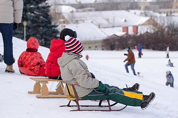 Image showing children sit wooden sledge ready slide from hill 