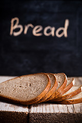 Image showing slices of rye bread and blackboard 
