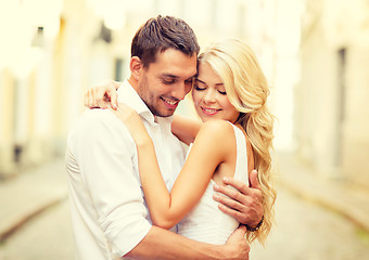 Image showing romantic happy couple hugging in the street