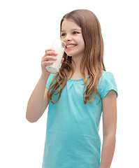 Image showing smiling little girl drinking milk out of glass