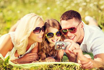 Image showing happy family with camera taking picture