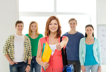 Image showing smiling students with teenage girl in front