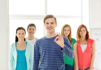 Image showing students with teenager in front showing ok sign