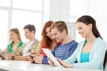 Image showing smiling students with tablet pc at school