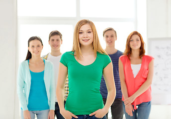 Image showing smiling students with teenage girl in front