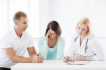 Image showing doctor with patients in cabinet