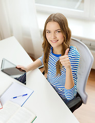 Image showing smiling student girl with tablet pc and books