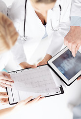 Image showing group of doctors looking at x-ray on tablet pc