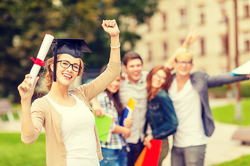 Image showing smiling teenage girl in corner-cap with diploma