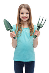 Image showing smiling little girl with rake and scoop