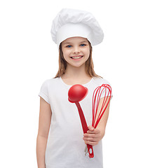 Image showing smiling girl in cook hat with ladle and whisk