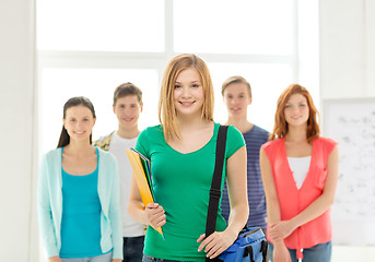 Image showing smiling students with teenage girl in front