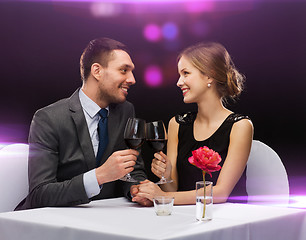 Image showing young couple with glasses of wine at restaurant