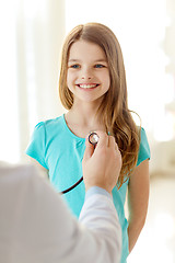 Image showing male doctor with stethoscope listening to child