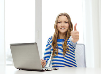 Image showing smiling teenage gitl with laptop computer at home