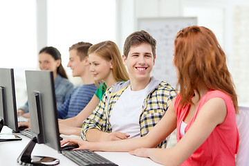 Image showing smiling students in computer class at school