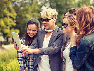 Image showing teenagers taking photo with tablet pc outside