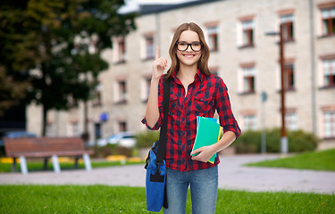 Image showing smiling female student with bag and notebooks