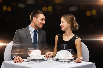 Image showing smiling couple looking at each other at restaurant