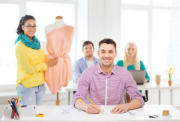 Image showing smiling fashion designers working in office