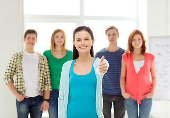 Image showing smiling students with teenage girl in front