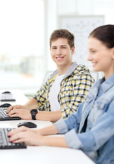 Image showing smiling boy with girl in computer class at school