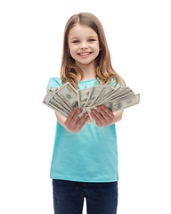 Image showing smiling little girl giving dollar cash money