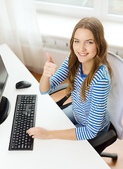 Image showing dreaming teenage girl with computer at home