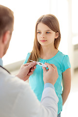 Image showing male doctor with child measuring temperature