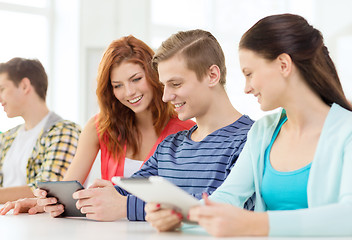 Image showing smiling students with tablet pc at school